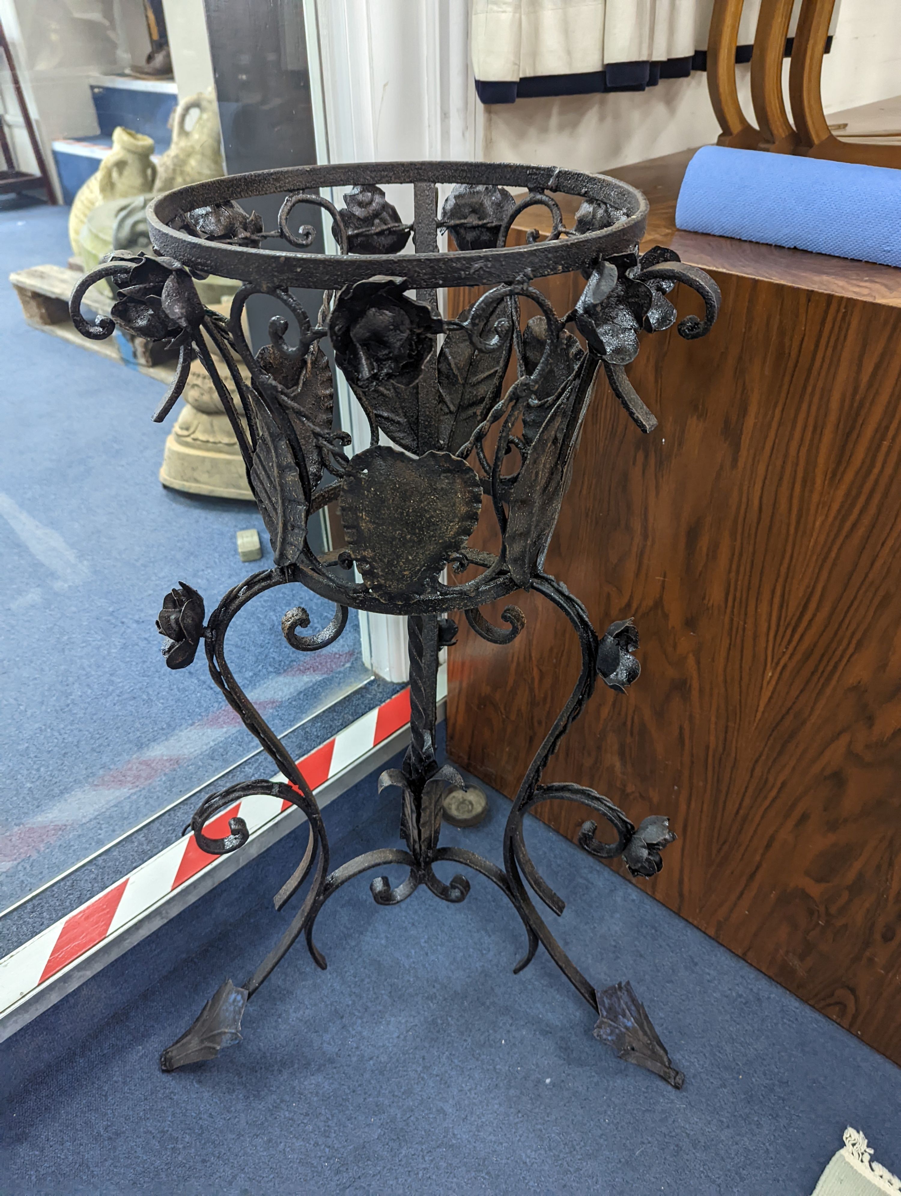 A pair of wrought iron garden planters, no liners, height 81cm